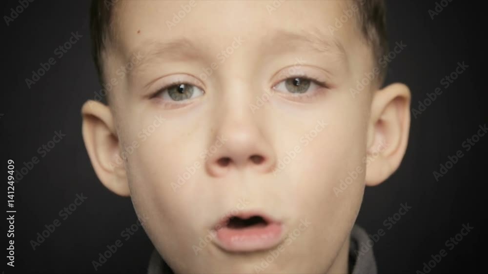Portrait of a boy close-up on a black background Portrait of a boy close-up on a black background