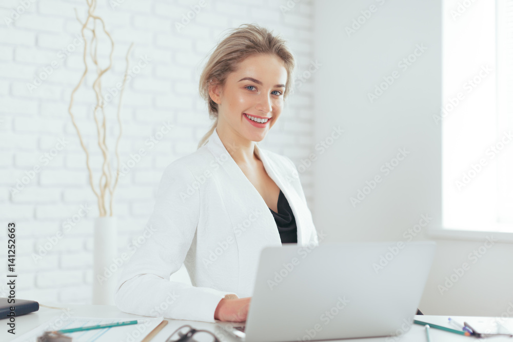 Portrait of beautiful young woman working in the office. Portrait of beautiful young woman working in the office.