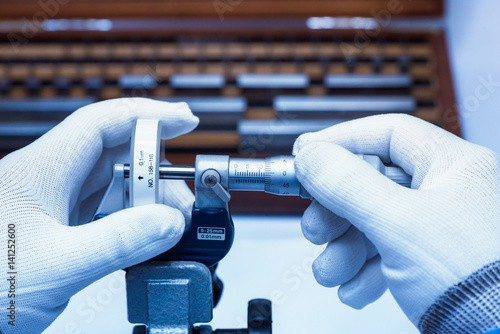 Micrometer Calibration with gauge block in laboratory. photo