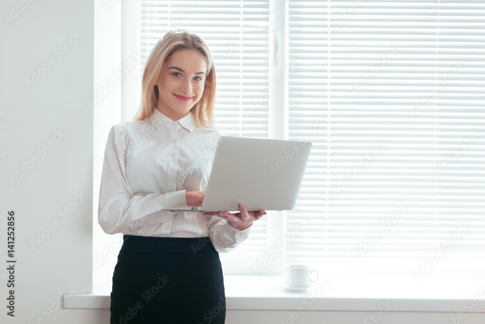 Portrait of beautiful young woman working in the office. Portrait of beautiful young woman working in the office.