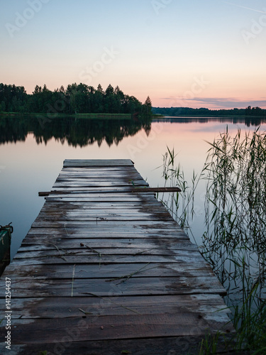 sunset over calm lake beach