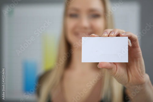 Blond business woman holding a business card hand