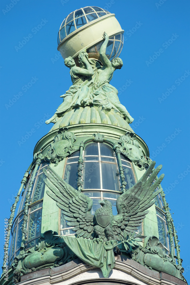 Dome of the building company Singer (1904) closeup on a sunny day. Saint Petersburg, Russia Dome of the building company Singer (1904) closeup on a sunny day. Saint Petersburg, Russia