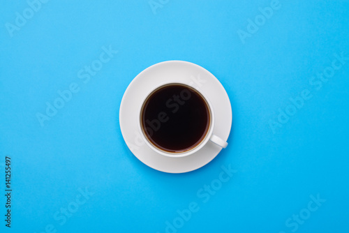 Top view of a dark flavor coffee isolated over blue flatlay