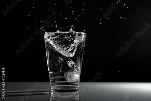 Splash ghiaccio in bicchiere d'acqua