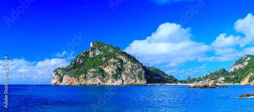 Beautiful summer panoramic seascape. View of the coastline into the sea bays with crystal clear azure water. Paleokastrica. Corfu. Ionian archipelago. Greece.