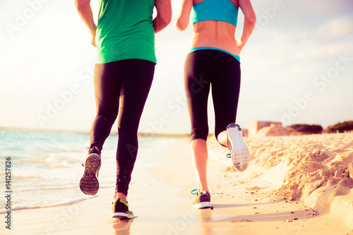 Young Couple Jogging On The Beach