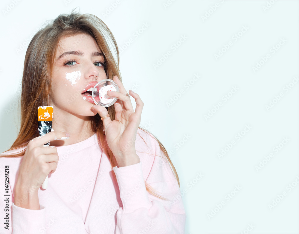 pretty girl putting facial cream or mask on face pretty girl putting facial cream or mask on face