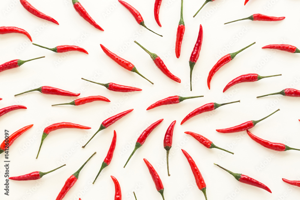 A lot of red hot chili peppers on a white background. a concept hot spice for food. top view, flat lay. Concept red food, many red peppers as background. A lot of red hot chili peppers on a white background. a concept hot spice for food. top view, flat lay. Concept red food, many red peppers as background.