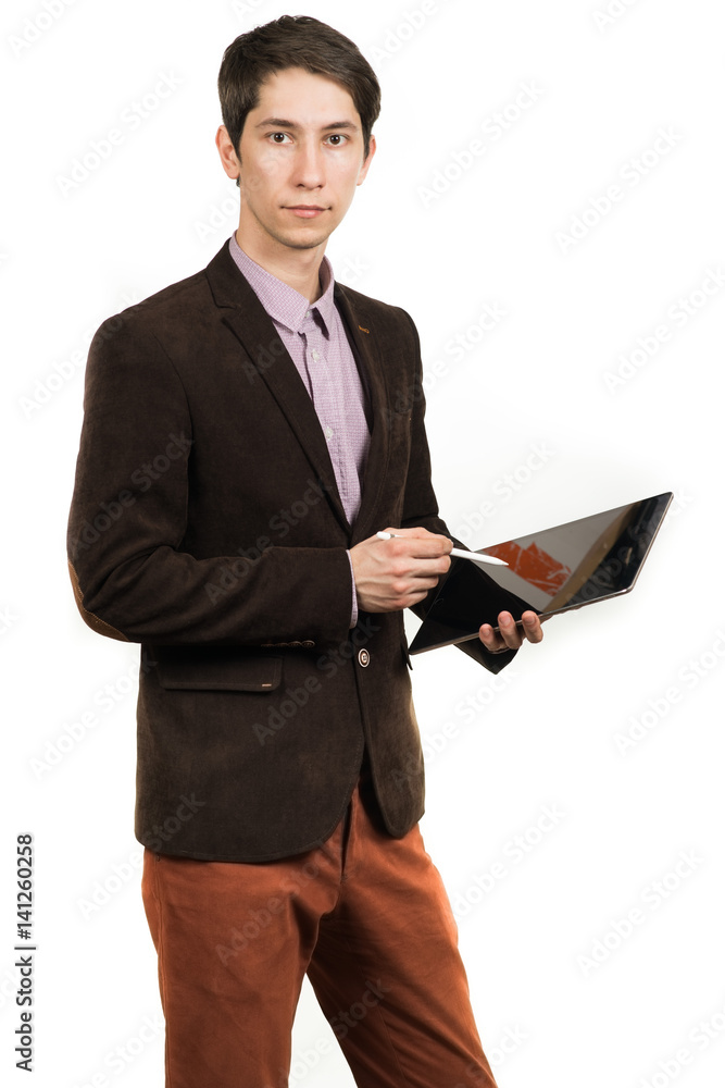 Cheerful young man businessman in suit working on digital tablet and smiling while standing isolated Cheerful young man businessman in suit working on digital tablet and smiling while standing isolated