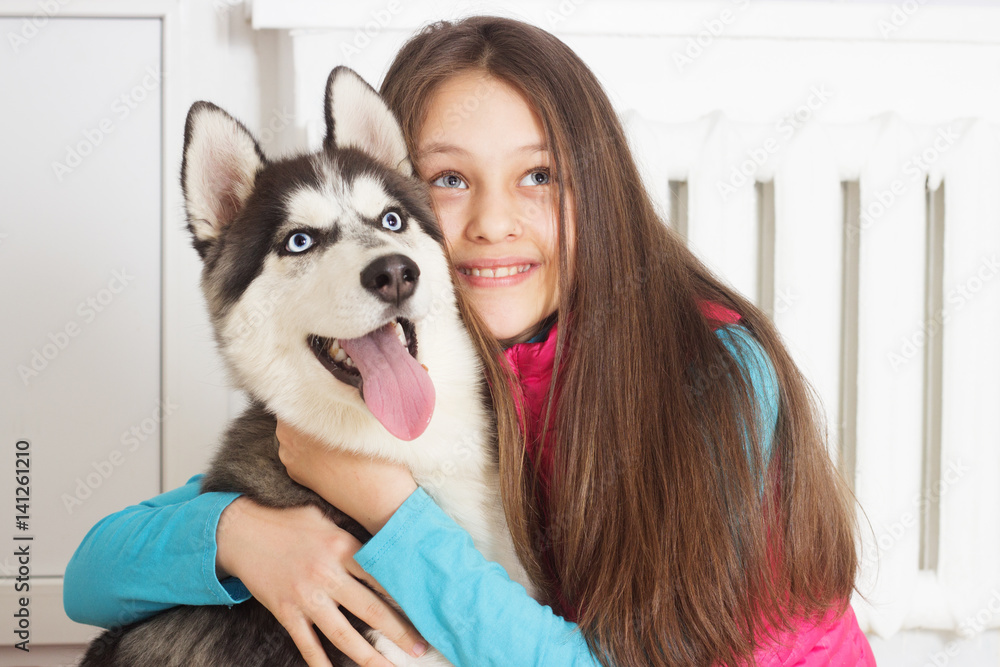 Girl and Siberian husky dog