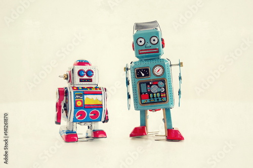 Filtered vintage tin toy robots isolated on white background