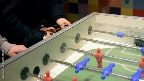 Hands playing table football photo