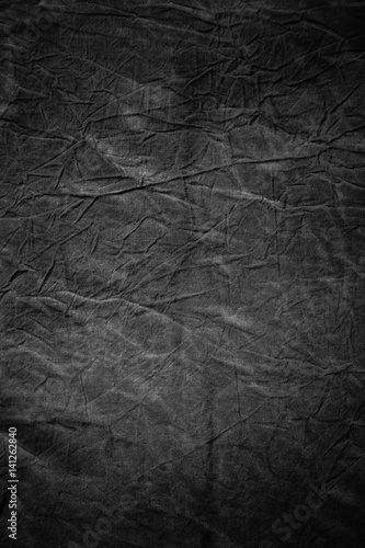 Texture of dark grey crumpled fabric