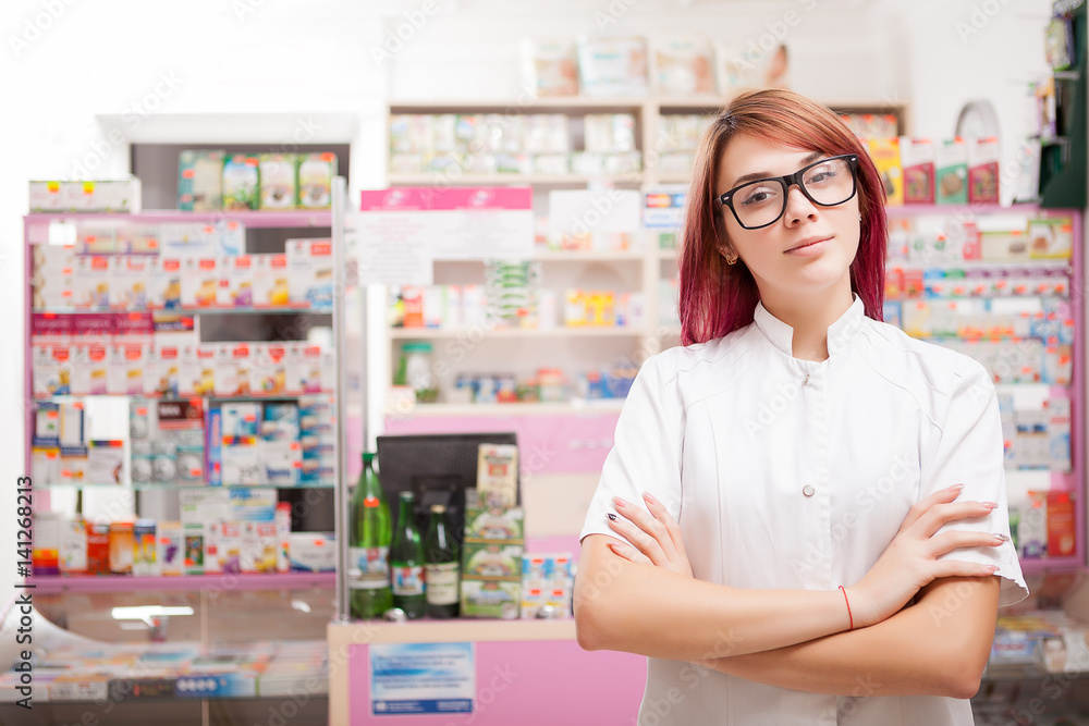 Pharmacist with glasses in front of her desk at work Pharmacist with glasses in front of her desk at work