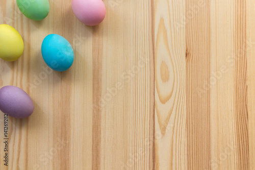Painting easter eggs on the wooden background