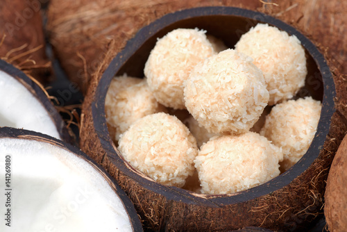 Homemade sweets in a coconut bowl. Toffee and coconut balls