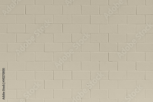Clean, freshly painted, tan, generic, brick cinder block wall background.
