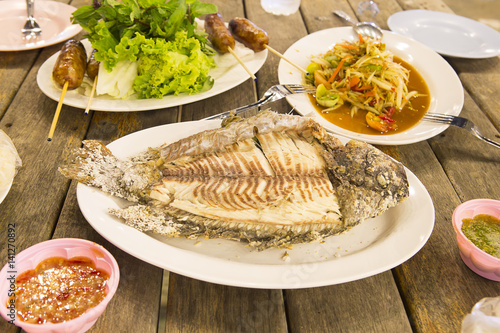 Salt-Crusted Grilled Fish, Flaming fish. photo