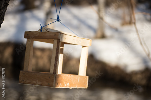 a bird feeder hanging on the tree