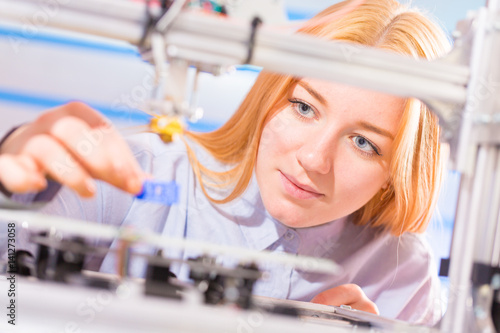 young woman in modern electronics laboratory