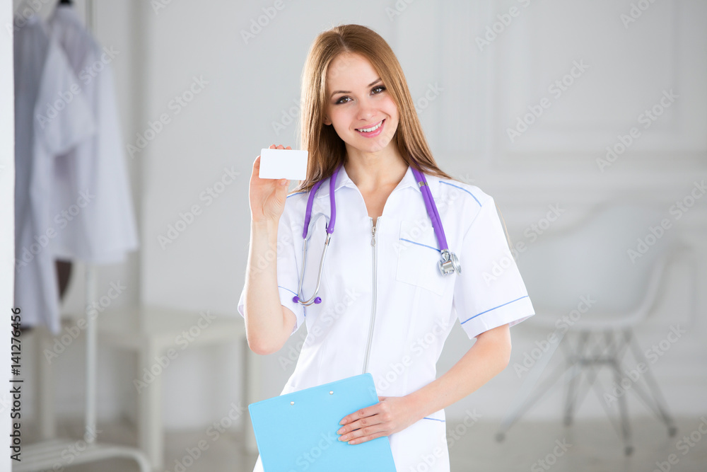 Smiling medical doctor showing business card sign, blank with copy space for text or design.