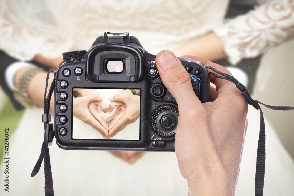 Professional Wedding Photographer taking pictures of bride and groom - obrazy, fototapety, plakaty 