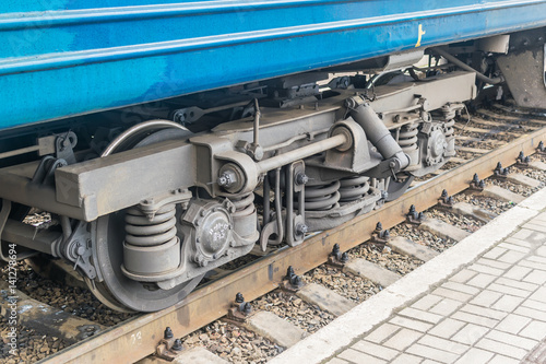 The wheels of a passenger train on rails