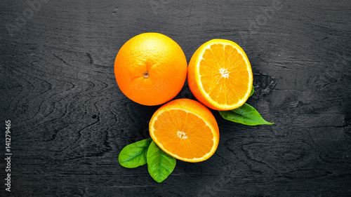Fresh citrus fruits. Orange. On a black background Wooden. Top view. © Yaruniv-Studio