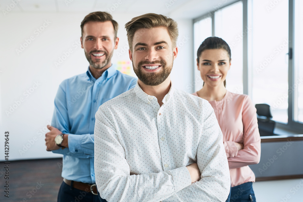 Group of successful business people standing together at office Group of successful business people standing together at office