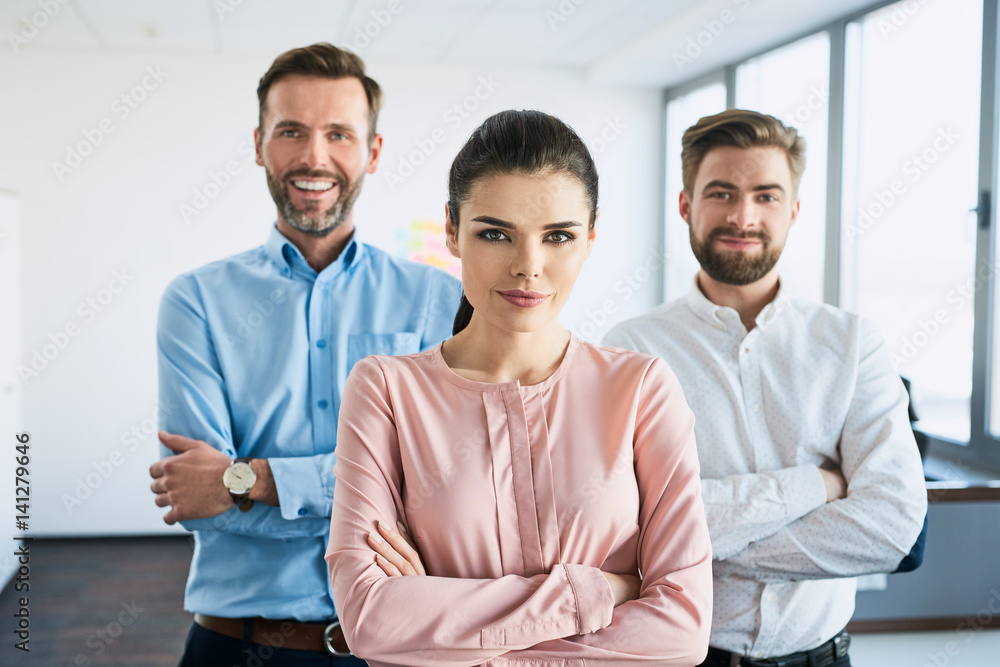 Group of business partners standing together at office Group of business partners standing together at office