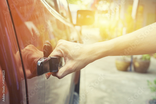 Hand on handle. Close-up of man in informalwear opening a car door,vintage color,morning light ,selective focus