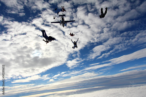 Skydivers in the amazing blue sky.