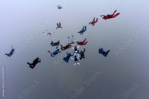 Skydivers make a formation in the sky.