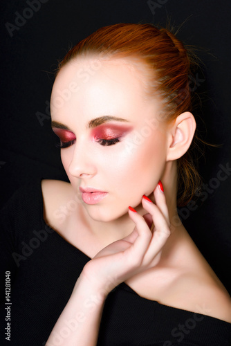 Beautiful girl with a gently pink make-up and covered eyes