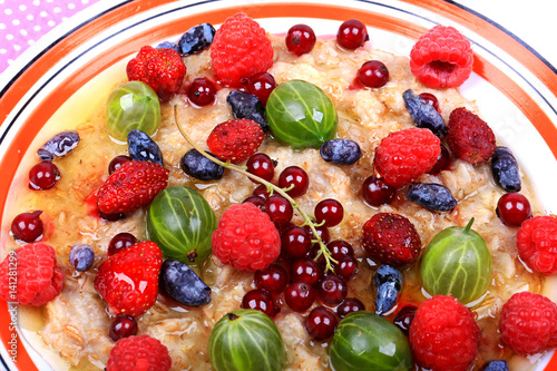 Fototapeta Naklejka Na Ścianę i Meble -  cereal with fresh berries and honey for a healthy heart useful breakfast