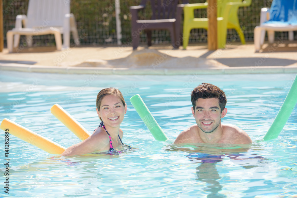 Naklejka premium adults with pool noodles