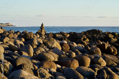 small stone figure at a stone beach