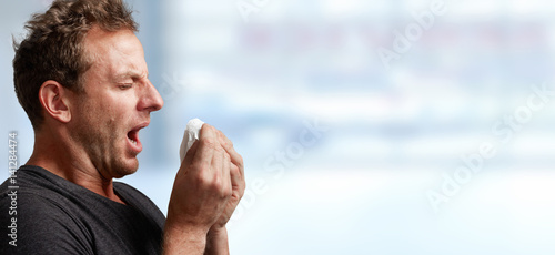 sneezing man with cold photo