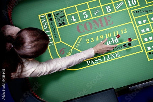 dice throw on craps table at casino photo