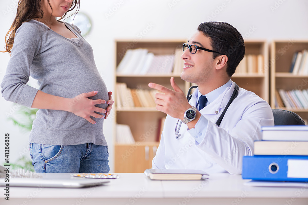 Fototapeta premium Pregnant woman visiting doctor for consultation