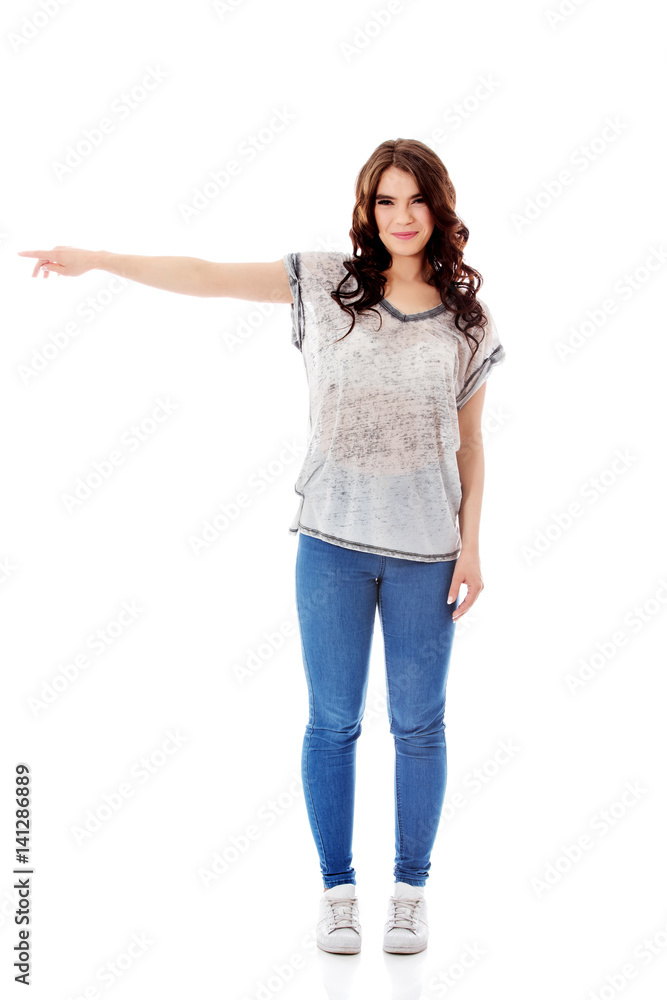 Portrait of a young woman pointing to the left. Portrait of a young woman pointing to the left.