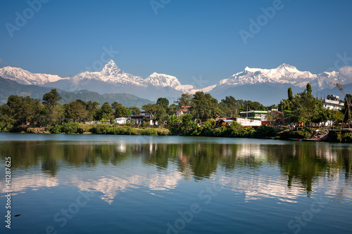 View at Annapurna mountain range and its reflection in Phewa lake in Pokhara, Nepal photo