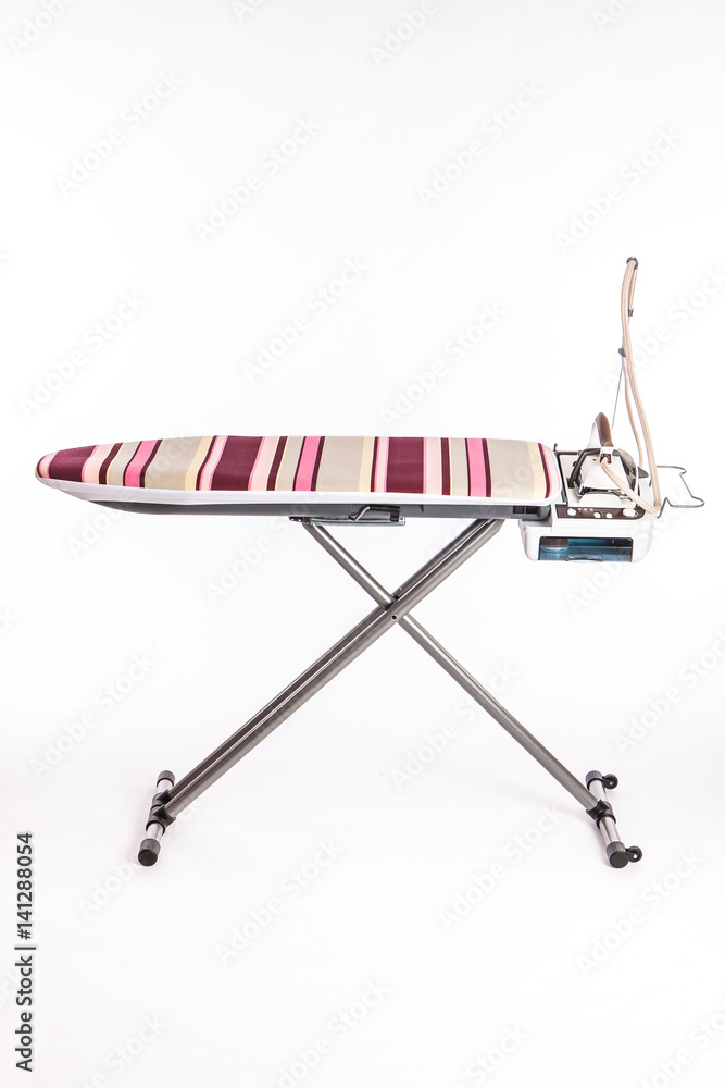 Iron close up on an ironing board. Iron close up on an ironing board.