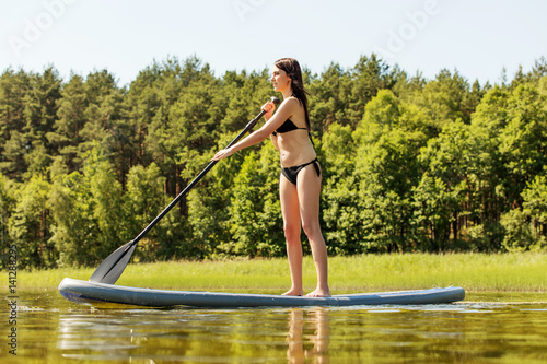 Stand up paddle board woman paddleboarding on SUP © Piotr Marcinski