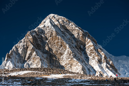 Trekker approaching PumoRi mountain in Khumbu valley on a way to Everest Base camp photo