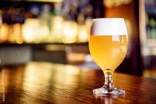 A glass of unfiltered beer on counter