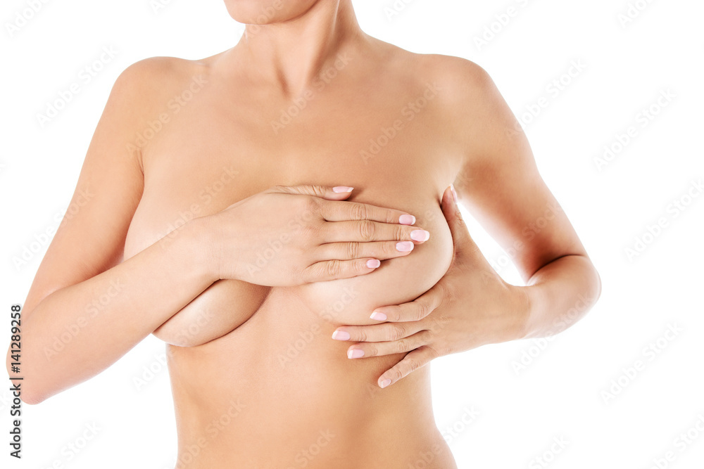 Young woman examining her breast for lumps or signs of breast cancer. Young woman examining her breast for lumps or signs of breast cancer.
