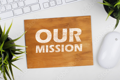 Wooden board with text our mission