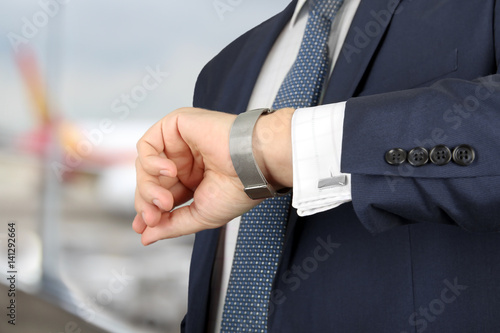  businessman checking time on his watch at the airport